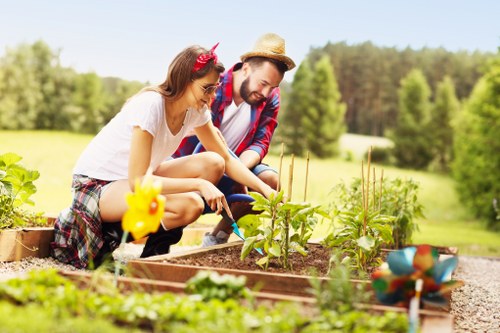 Gardening crew operating mowers with protective gear